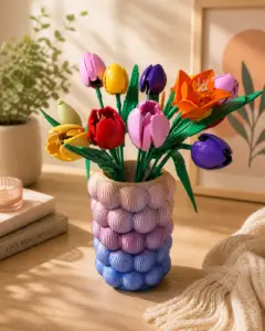 Pastel rainbow 3D printed vase holding colorful LEGO tulip flowers on a wooden table